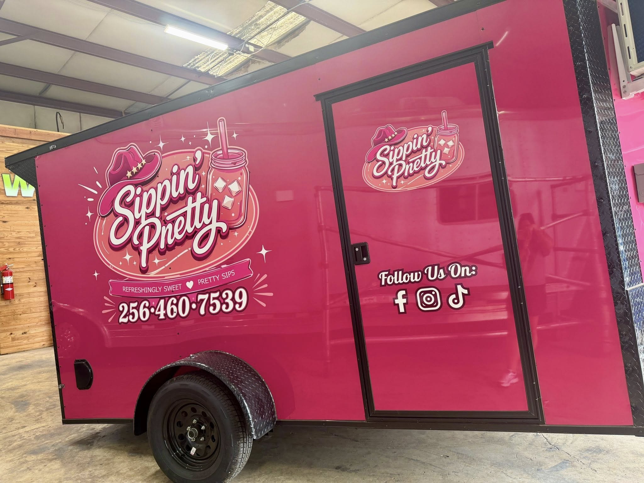 The hot pink Sippin' Pretty mobile drink trailer